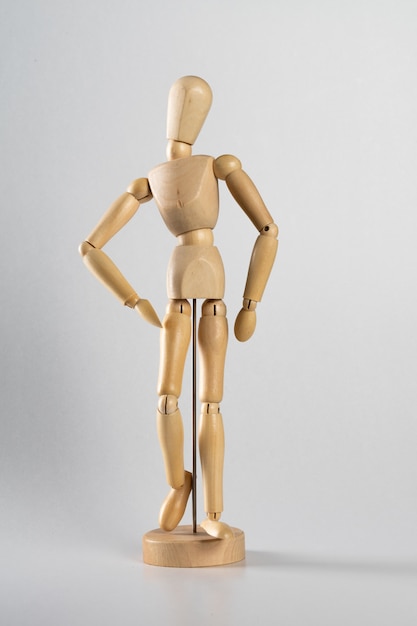 wooden pose doll posed like it's walking forward