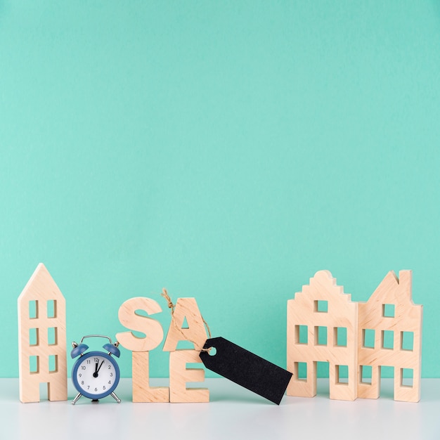 Free Photo wooden sale lettering next to wooden houses