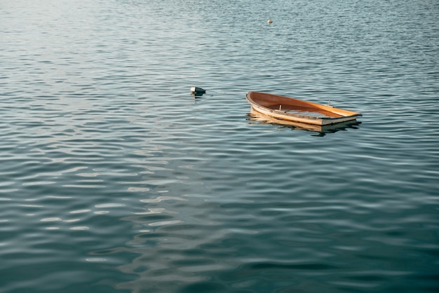 Free Photo wooden small boat sinking on a calm lake in pais vasco, spain