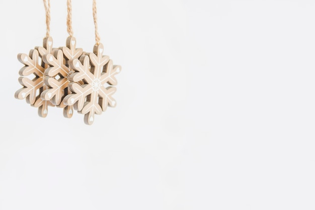 Free photo wooden snowflake ornaments on white backdrop