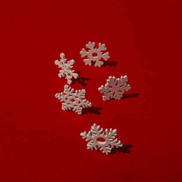 Wooden snowflakes on red table