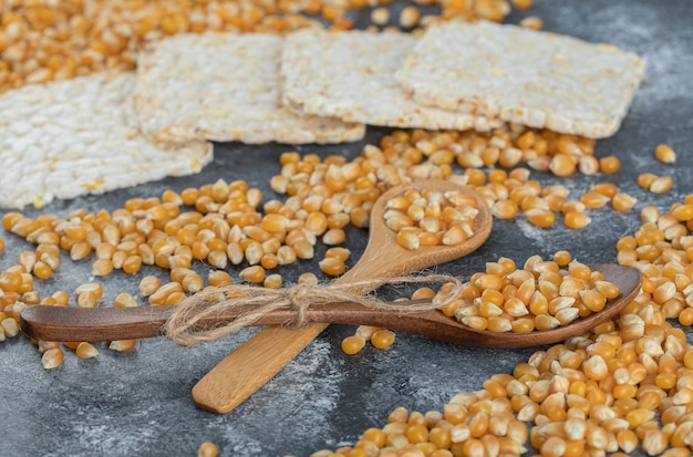 Wooden spoons of sweet corns with crispy rice bread.