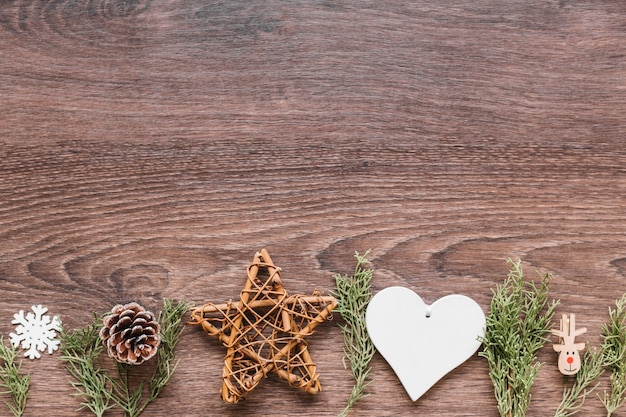 Free Photo wooden star with green branches on table 