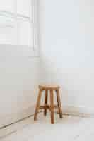 Free photo wooden stool in the corner of a room