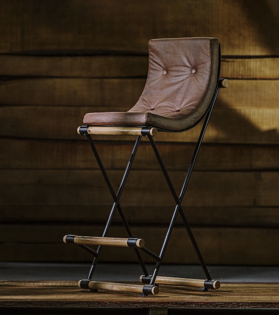 Wooden stool with a leather cushion and metal legs