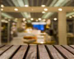 Free photo wooden surface looking out to blurred shop