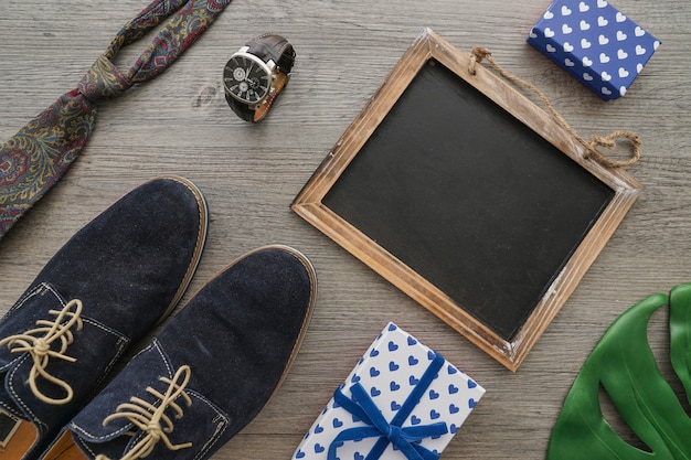 Wooden surface with blank slate and other elements for father's day