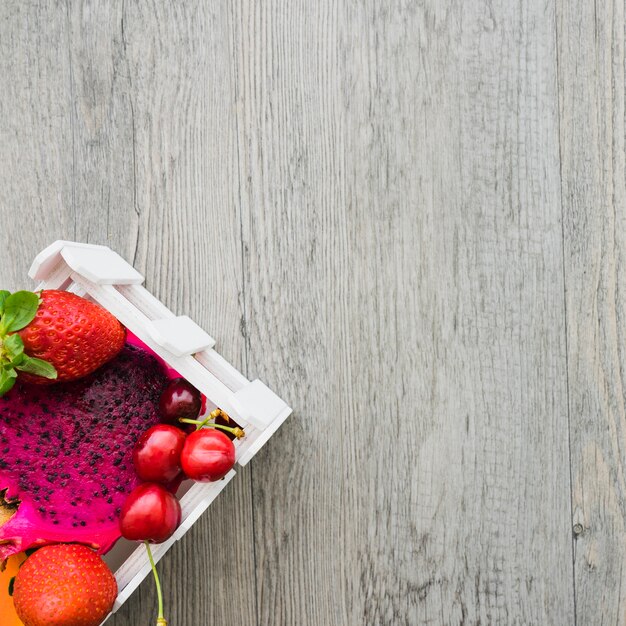 Wooden surface with blank space and fruits