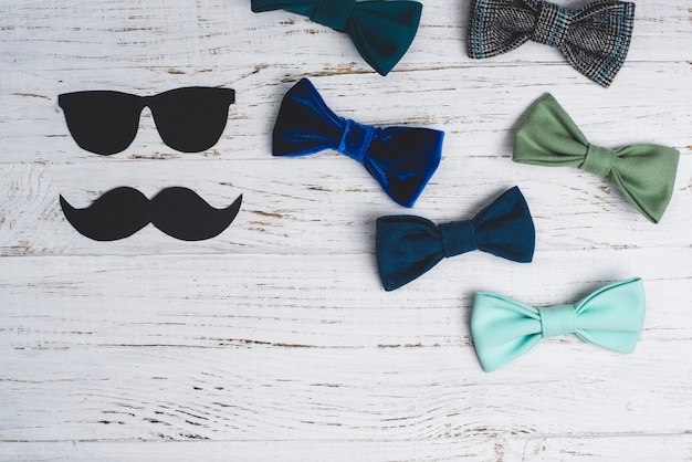 Free Photo wooden surface with bow ties for father's day