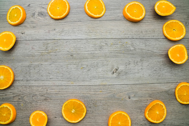 Wooden surface with frame made with orange slices