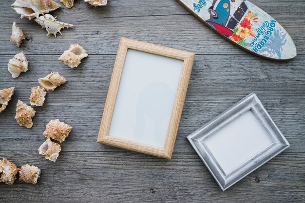 Wooden surface with frames, surfboard and seashells