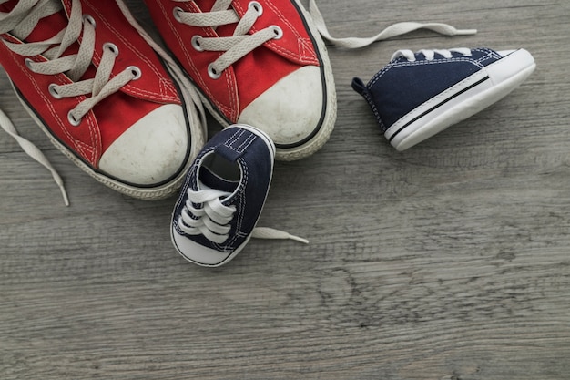 Free photo wooden surface with shoes and space for messages