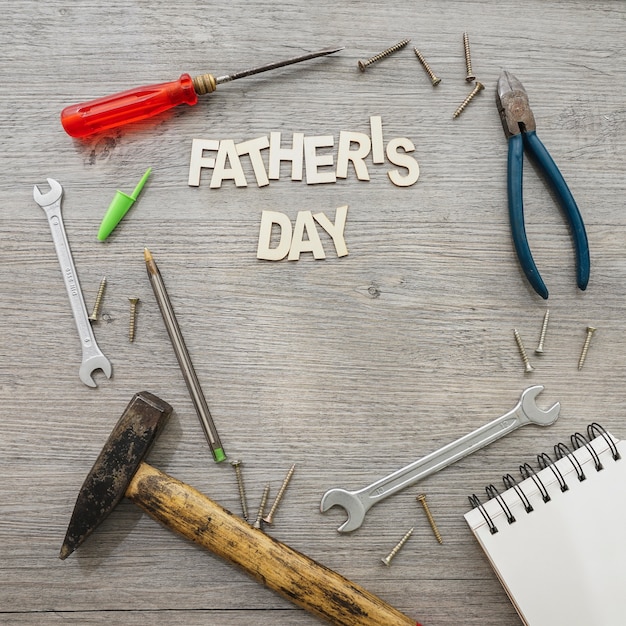 Free Photo wooden surface with tools and notebook for father's day