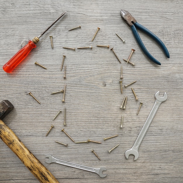 Wooden surface with tools and screw frame