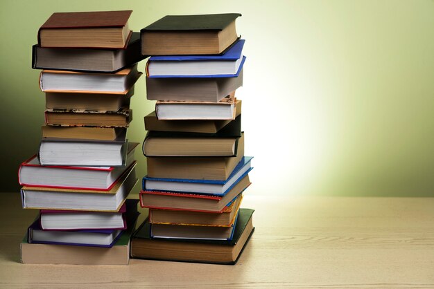 Wooden surface with two mountains of books