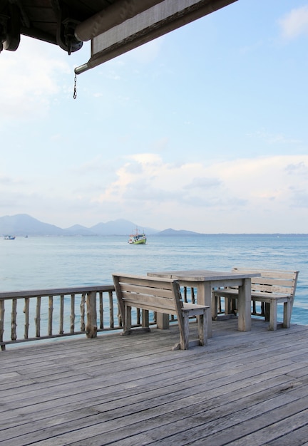 Free Photo wooden table and chairs on a tropical beach resort