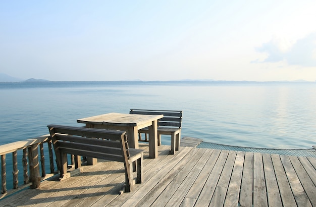 wooden table and chairs on a tropical beach resort