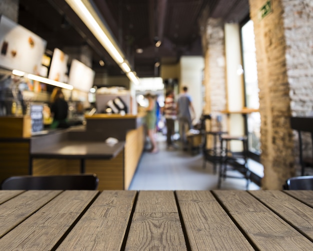 Free Photo wooden table looking out to bar with big windows