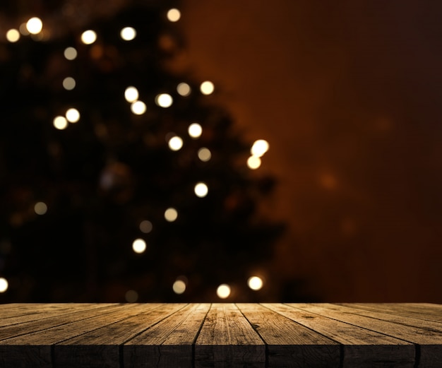 wooden table looking out to a defocussed Christmas tree