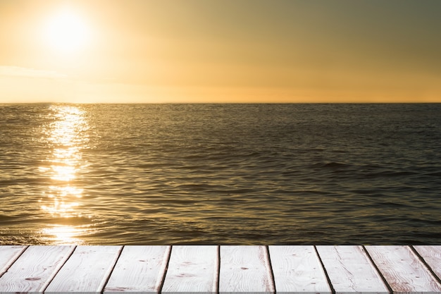 Free Photo wooden table at sunset