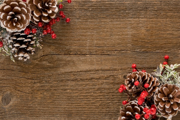 Wooden table with pine leaves and cones