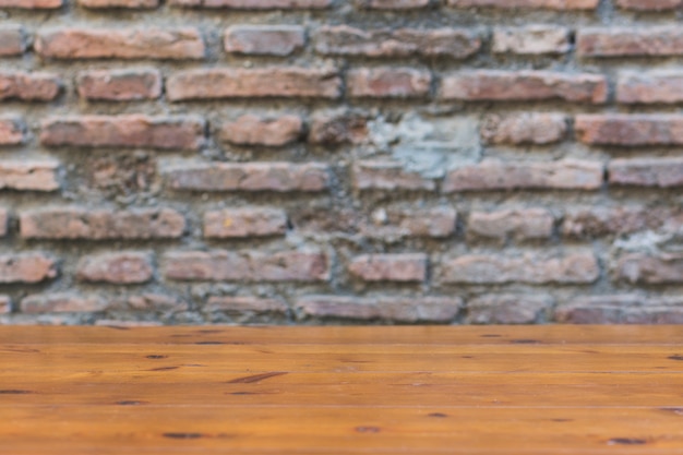 Free Photo wooden tabletop near crumbling brick wall