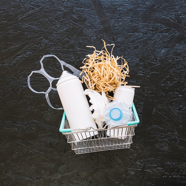 Woodshave and plastic bag in metal basket