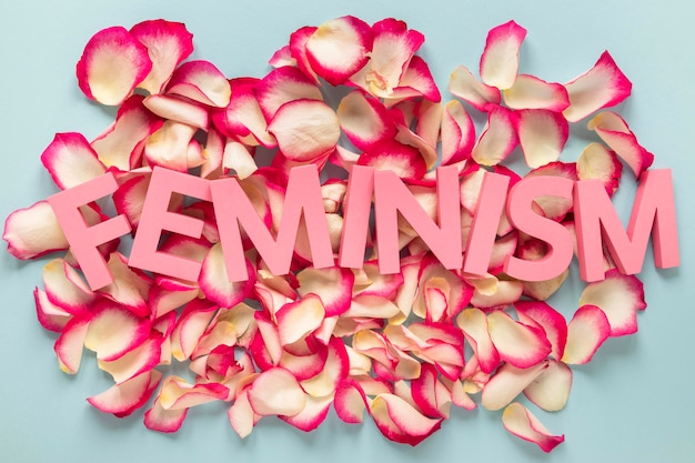 Free photo the word feminism on top of rose petals