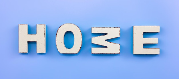 Free Photo the word home from wooden letters on a blue background