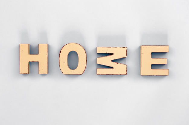 Free Photo the word home from wooden letters on a white background