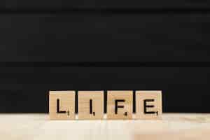 Free photo the word life spelt with wooden letters