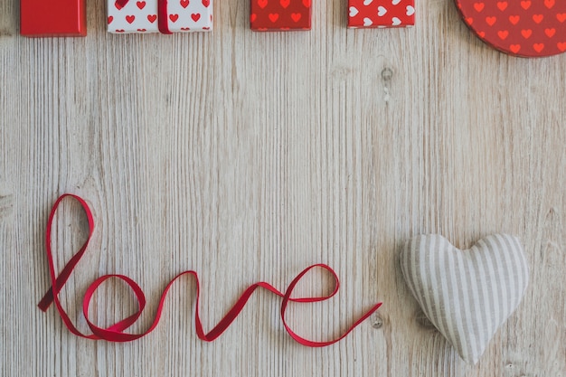 Word "love" with gifts upstairs and a white fabric heart next to it