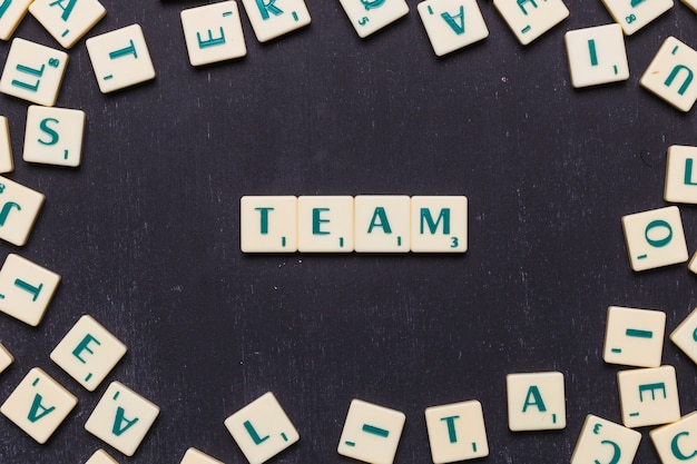 Word team in scrabble letters over black backdrop