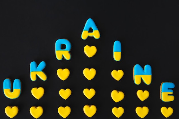 Free Photo the word ukraine on a black background made with handmade gingerbread