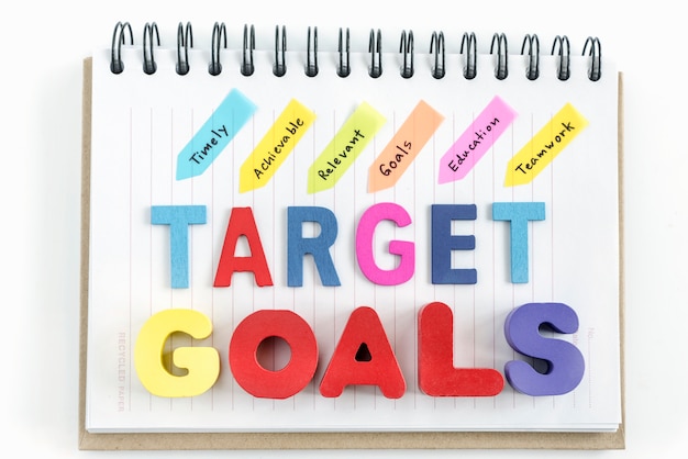 Free Photo words goals target on notebook over white background