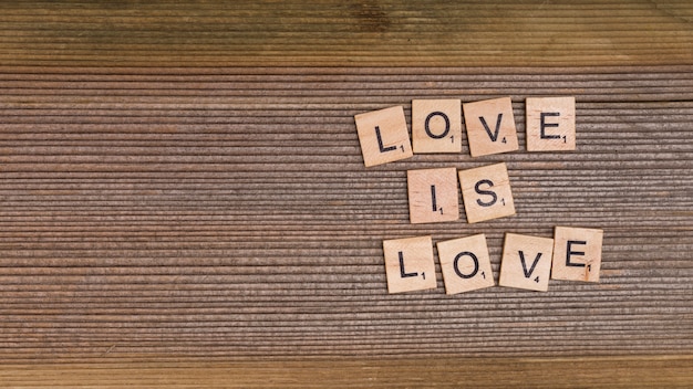 Free Photo words love is love from wooden elements