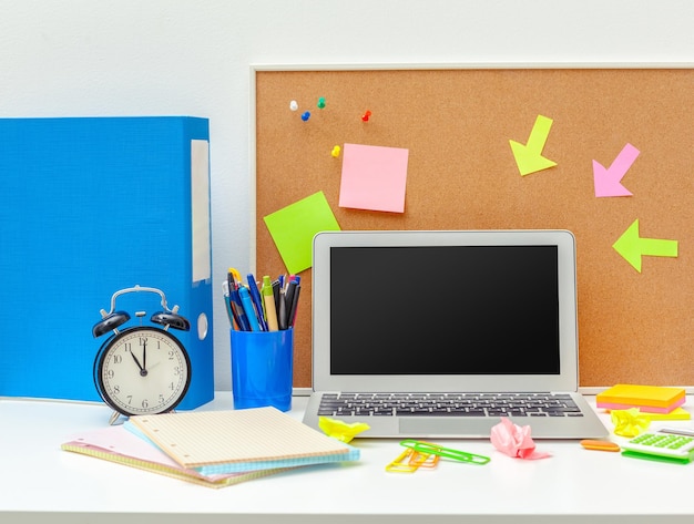 Work place of a creative person with a variety of colorful stationery objects