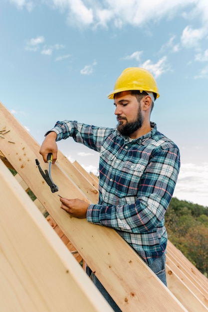 Free photo worker building the roof of the house