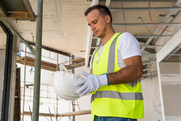 Free Photo worker on a construction site holding a helmet