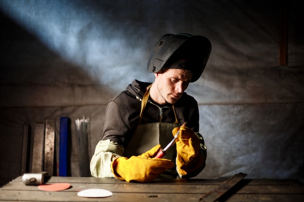 Free photo worker holding plasma equipment in steel factory.