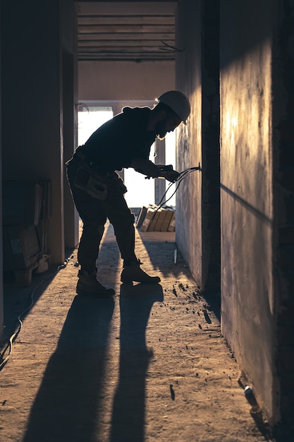 Free photo worker is cutting wires with lineman's pliers.