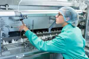 Free photo worker operates the machine at the enterprise clean room with stainless steel hardware