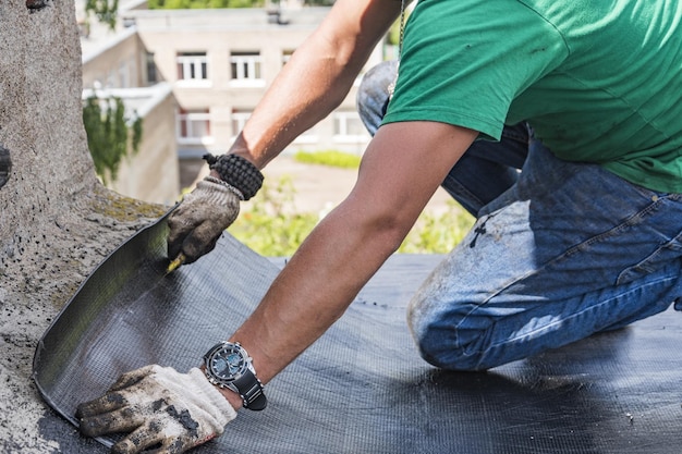 Worker performs overhaul of the roof of a residential building