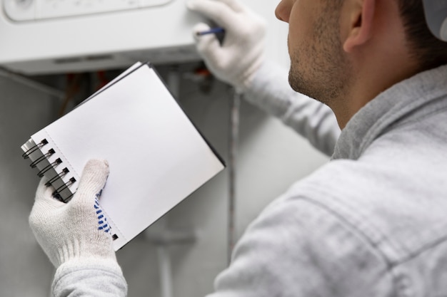 Free photo worker repairing water heater