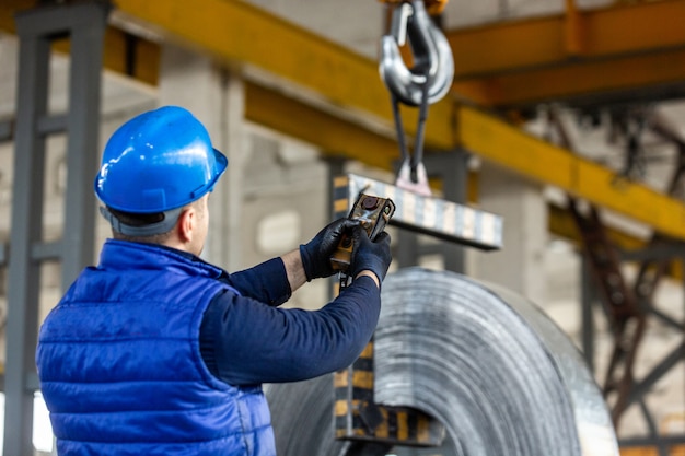 Free Photo worker uses control joystick in factory