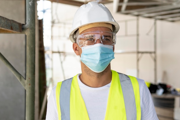 Free photo worker wearing medical mask on a construction site