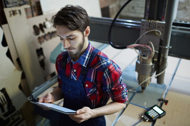 worker with tablet settings