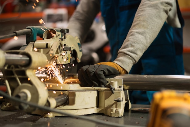 Worker working with a circular grinder on a metal with sparks