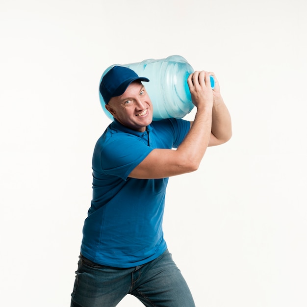 Free photo working delivery man holding water bottle