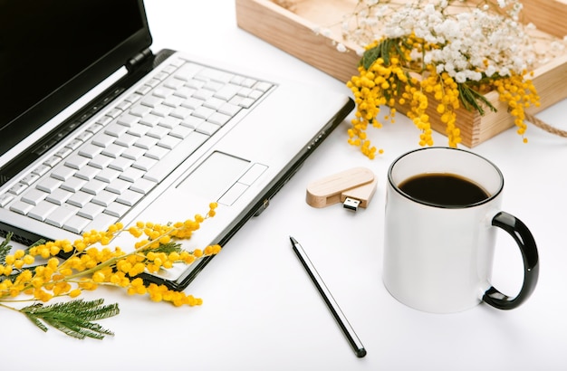 working set for spring holidays with flowers and office laptop flash drive 